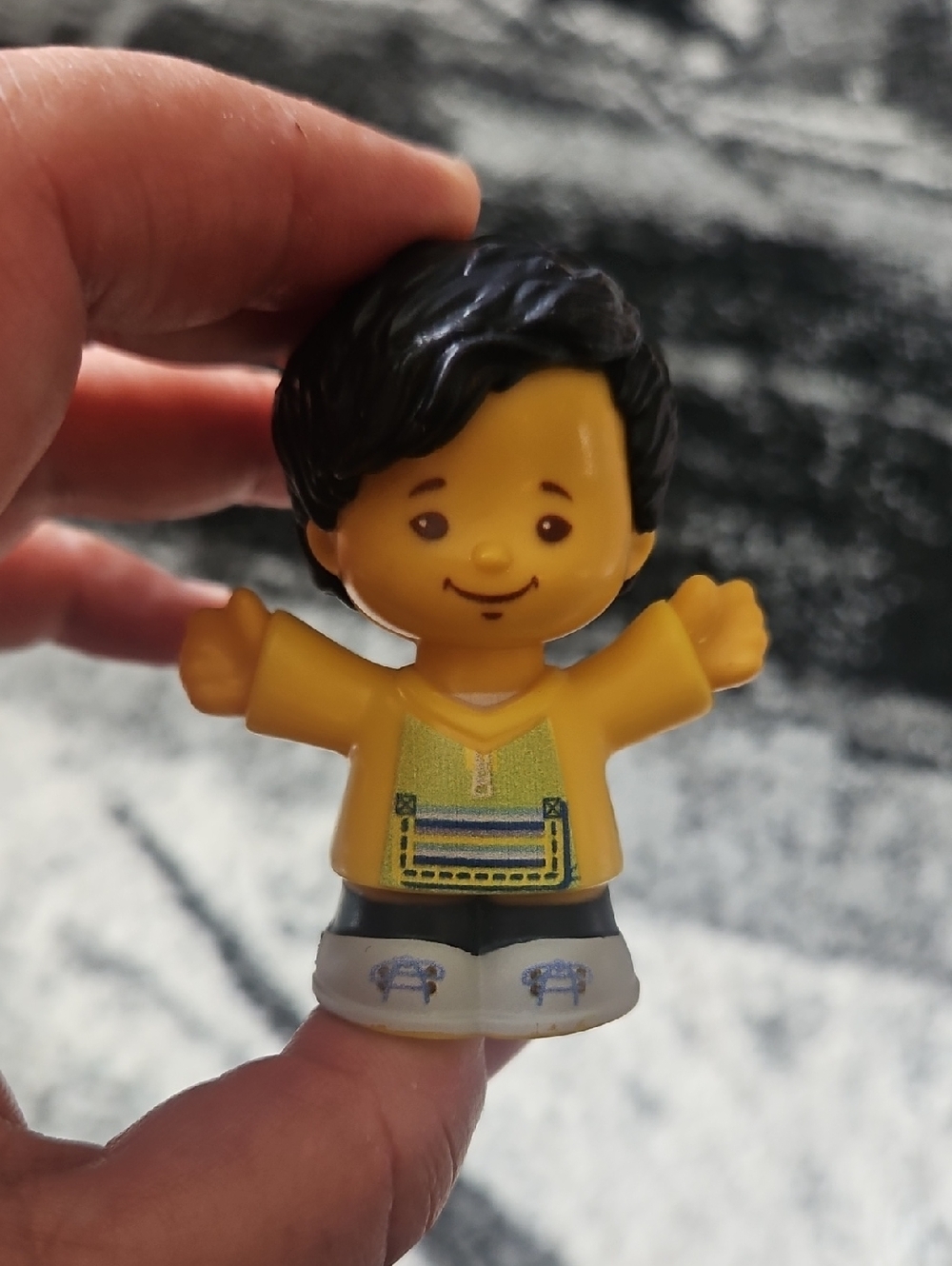Fisher-Price Little People Koby figure wearing a yellow shirt